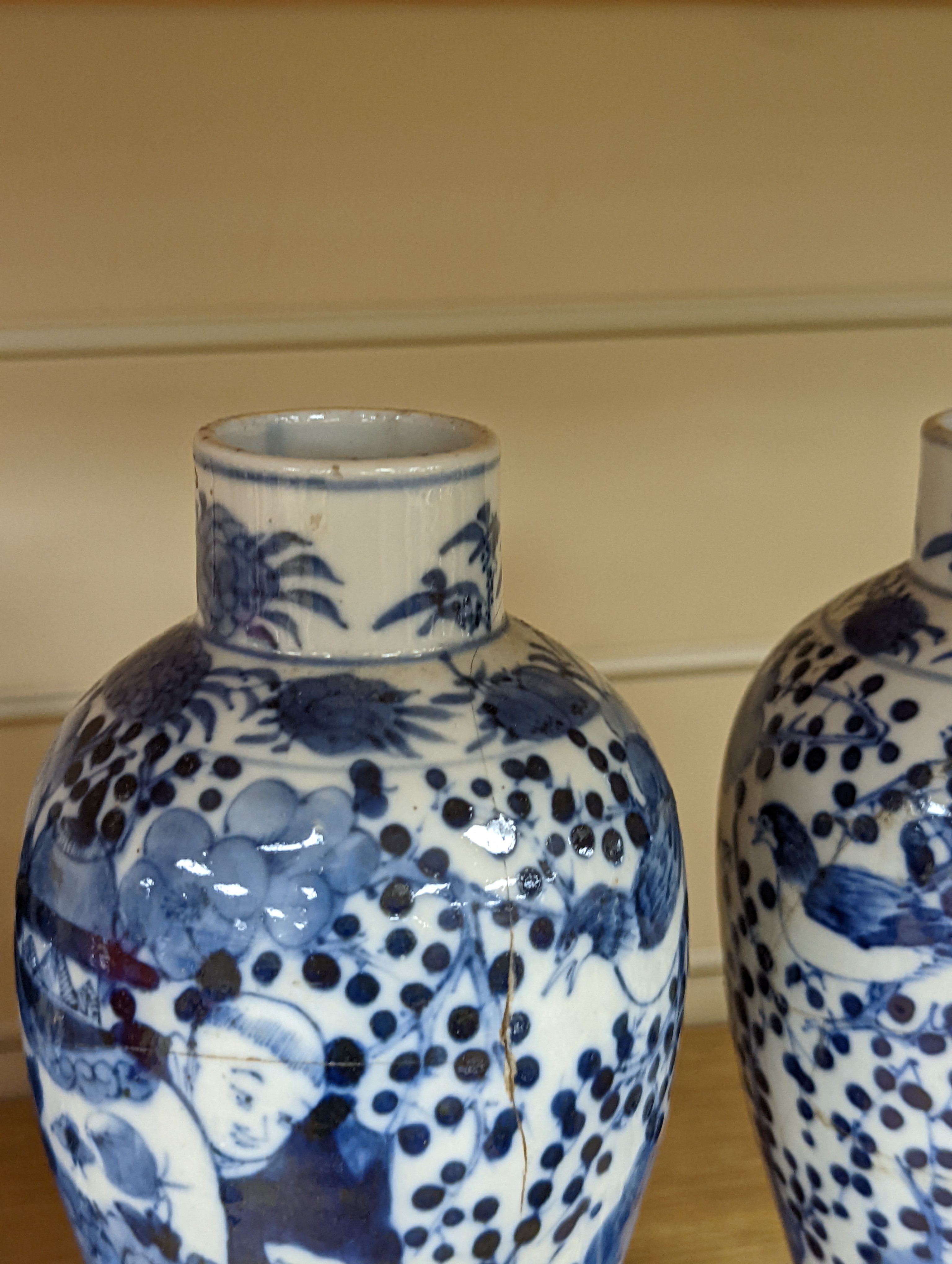 A pair of 19th century Chinese blue and white vases, a prunus vase and cover and a similar jar (4), pair of vases 24 cms high.